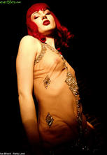 Ultra glamorous pierced redhead in see thru dress
