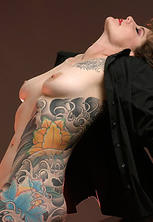 Tattooed milf shows off extensive ink
