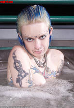 Ultra tattooed pierced slut spreads in hot tub