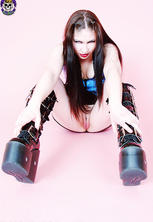 Dominant fetish brat in boots and latex waving her shotgun