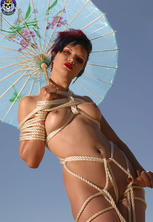 Colorful goth girl in shibari rope bondage