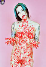 Red-spattered pale vampire beauty with considerable tattoos