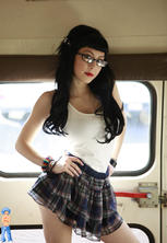 Hot gothic schoolgirl in glasses flashing on schoolbus