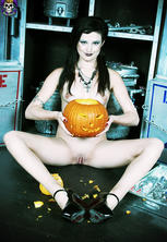 Classic naked goth babe carving halloween pumpkin. 