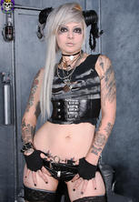 Tattooed industrial beauty in boots and leather 