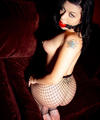 blackhaired girl in fishnets bound and ballgagged