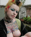 Hot tattooed punk babe by gravestone