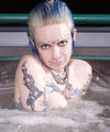ultra tattooed pierced slut spreads in hot tub
