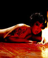 slim Eurasian girl in red fishnet Satanic flames