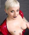 Tattooed and pierced blonde in red rubber glory