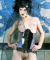 Fashionable corsetted Gothic beauty undressed